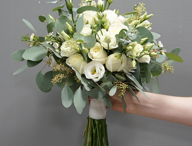 Bridal bouquet of white rose, eustoma, dianthus, eucalyptus and waxflower photo